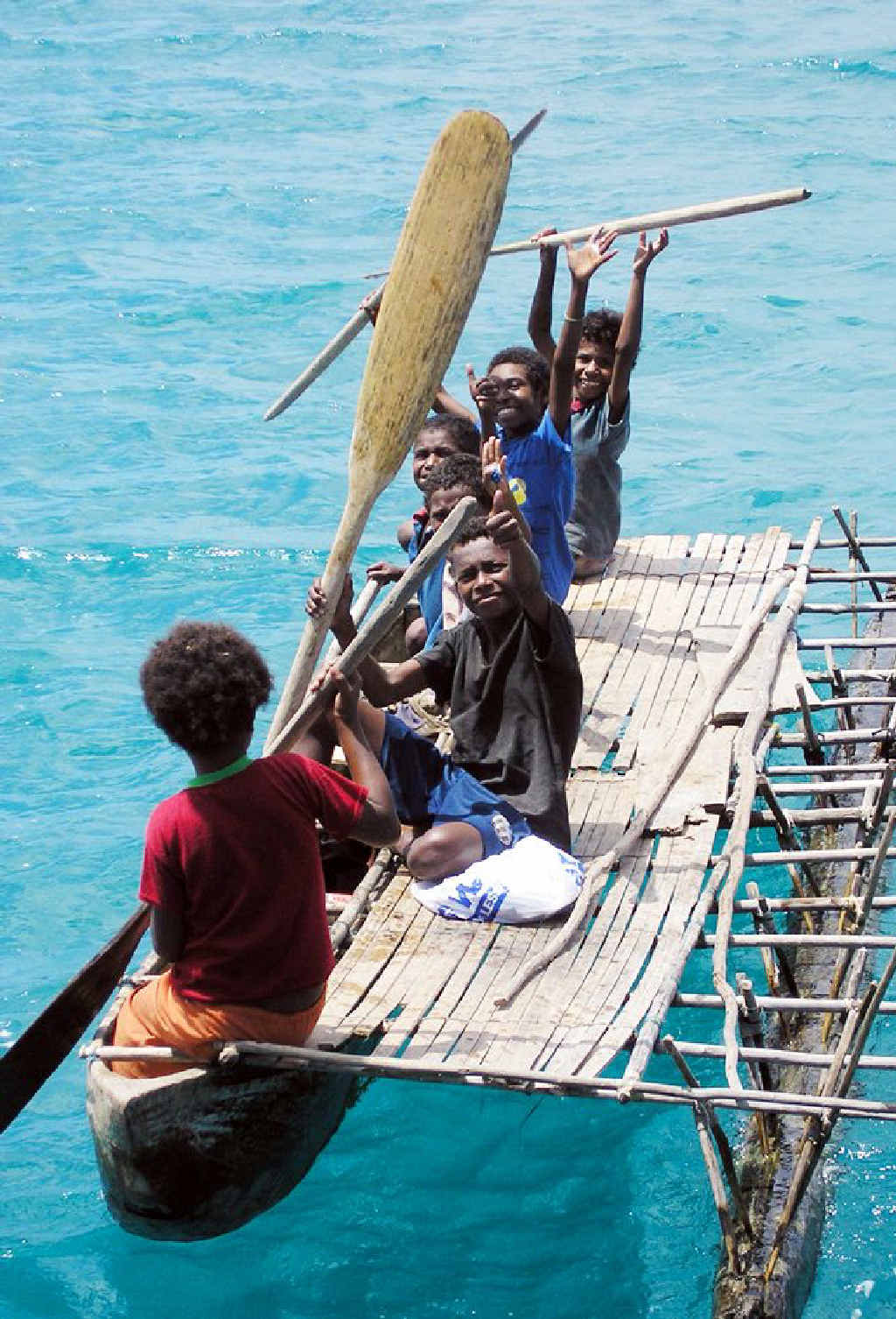 Boys on one of the basic canoes people on the island use for transport. Boys on one of the basic canoes people on the island use for transport.